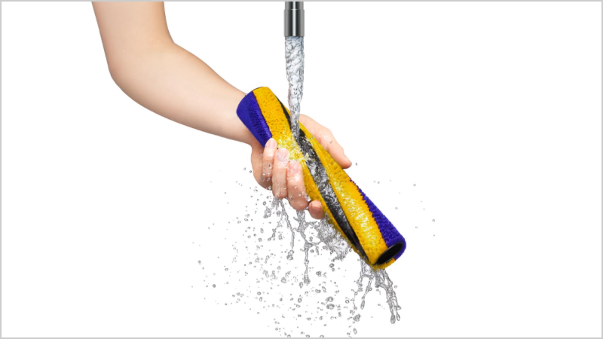 Dyson removable parts being washed in water