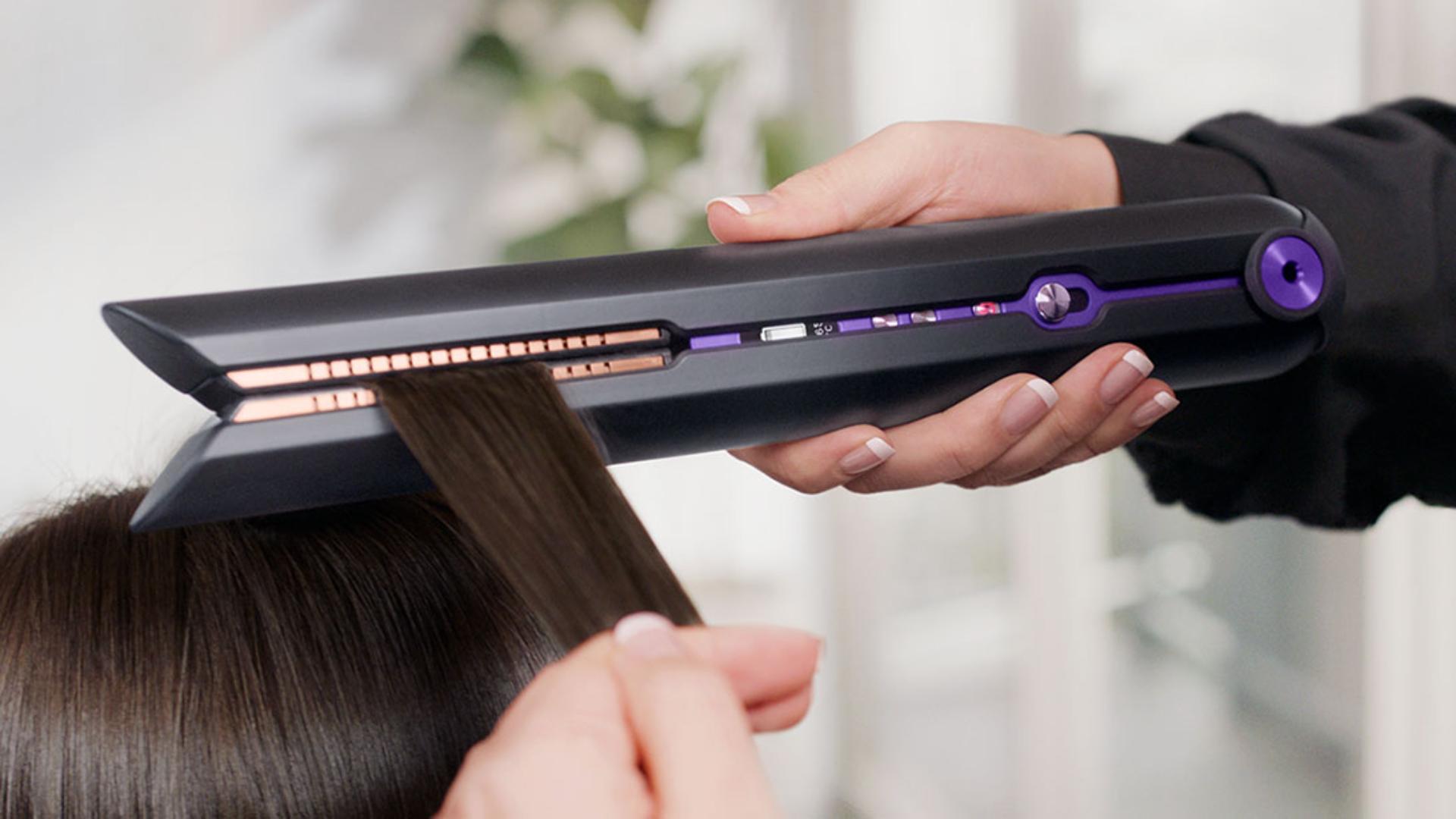 Professional stylist using the Dyson Corrale hair straightener