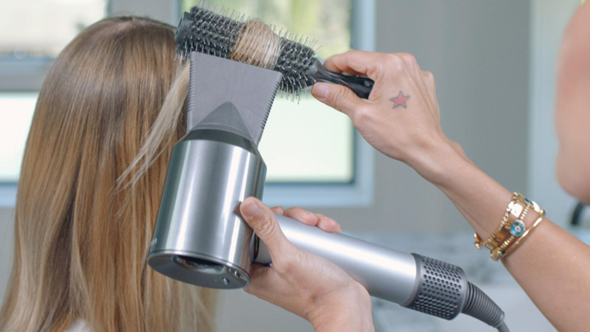 Professional stylist using the Dyson Supersonic hair dryer Professional