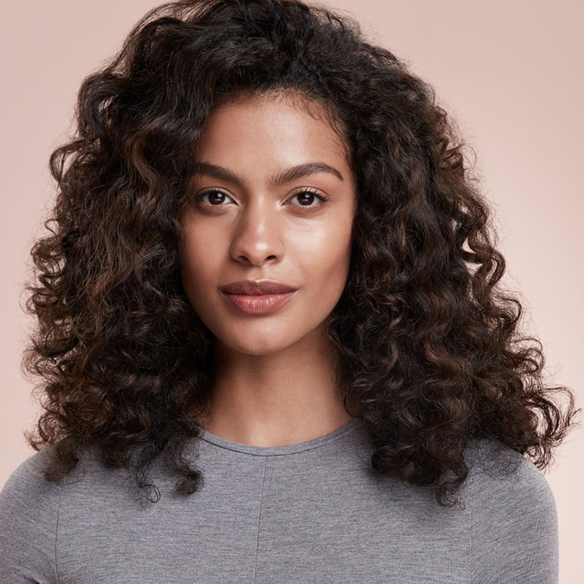 Model with defined curls using he Dyson Supersonic hair dryer