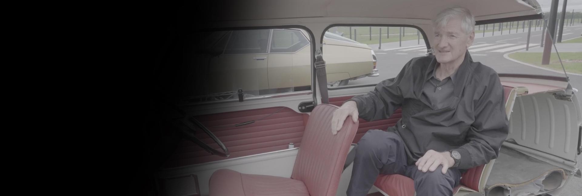 James Dyson sat in the back of old car