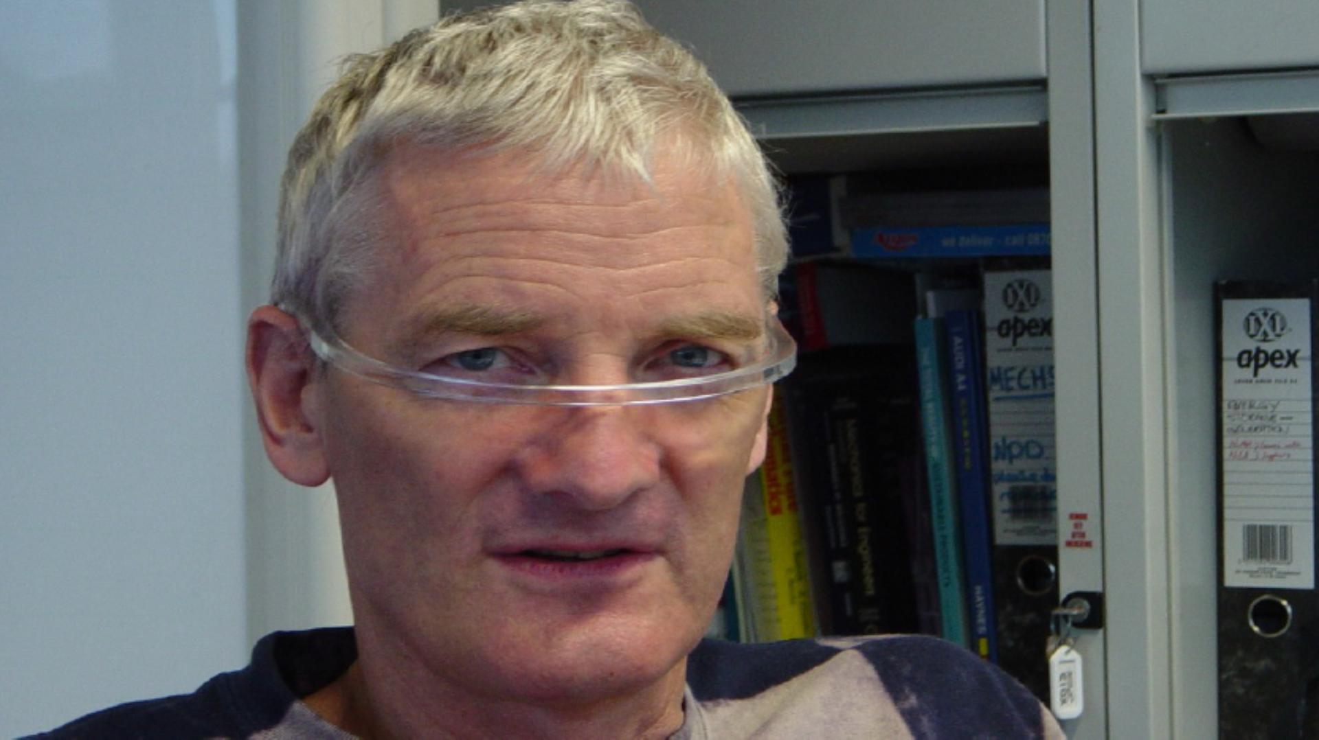 Close up portrait photo of James Dyson wearing the Halo prototype