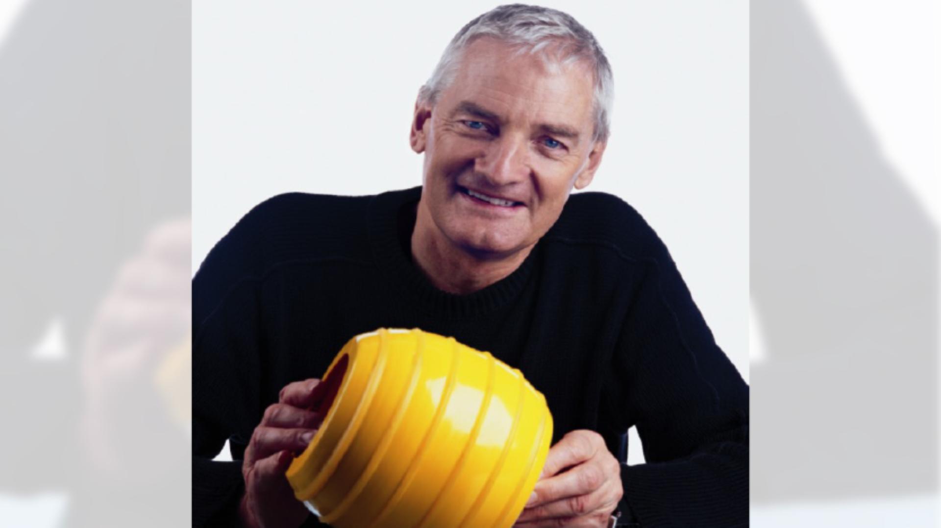 Close up James Dyson photo, with James holding a ball from the Ballbarrow design