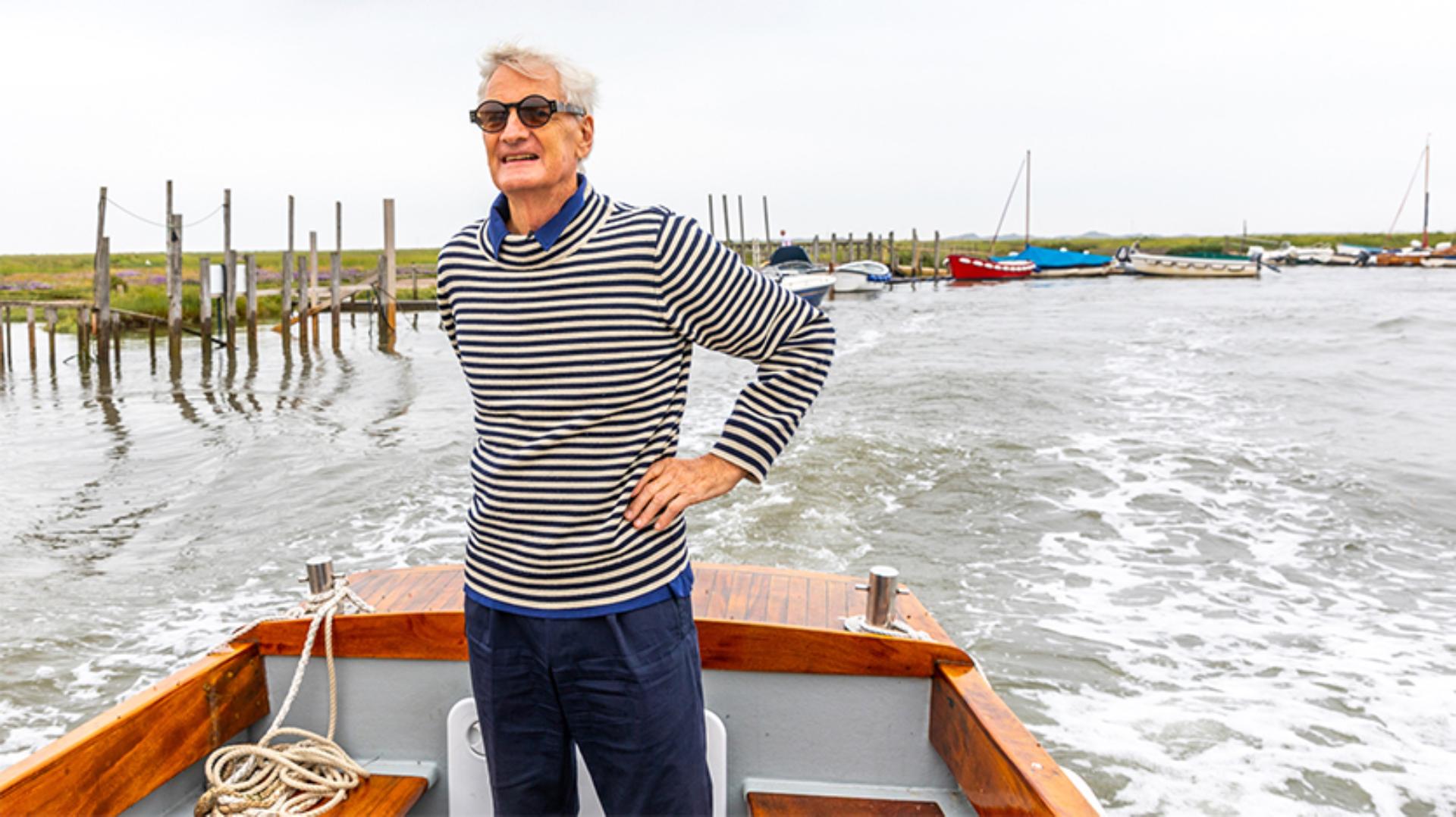 James Dyson standing on a boat at Blakeney Point