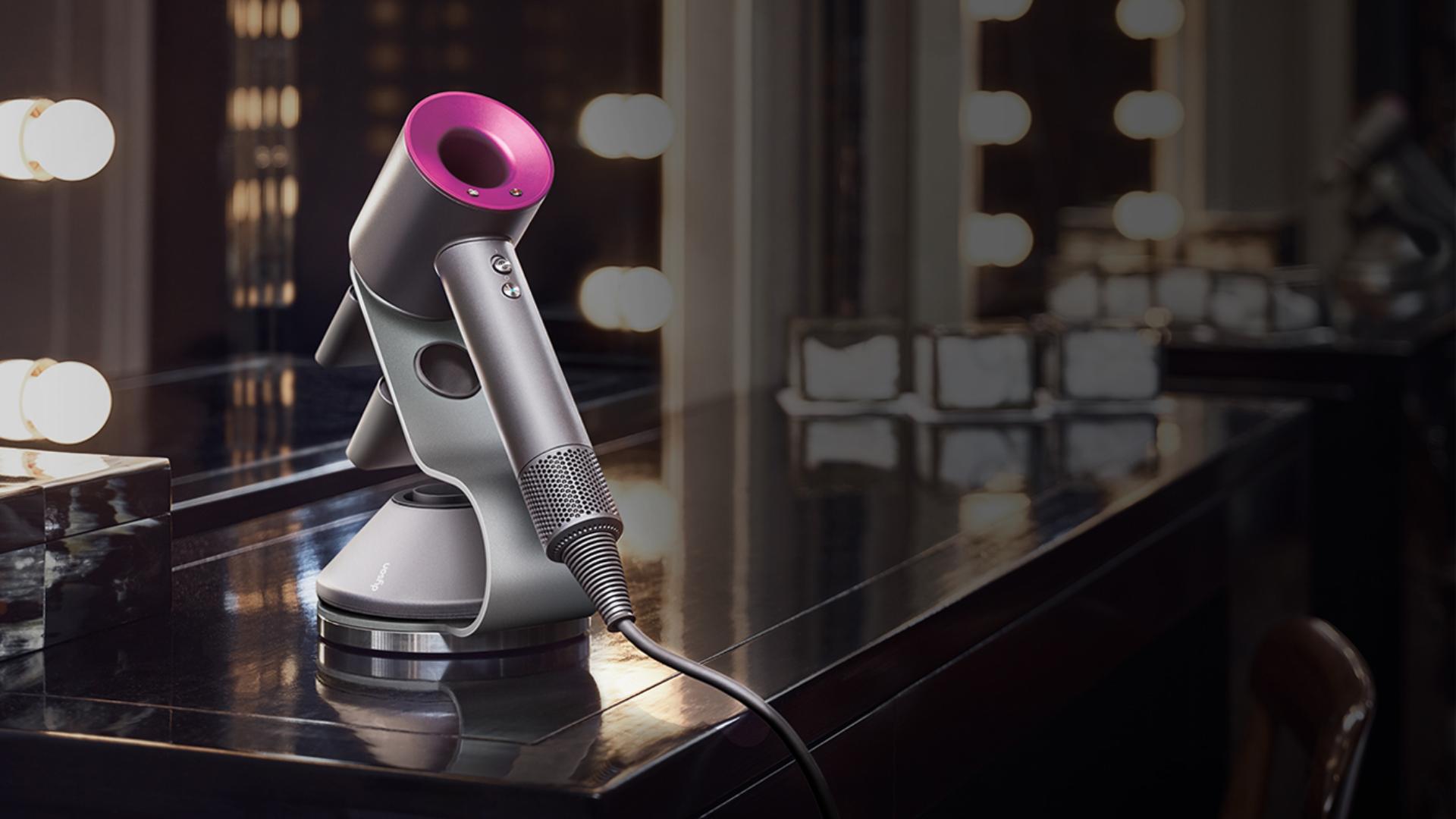 Dyson Supersonic hair dryer on a desk in a hotel room