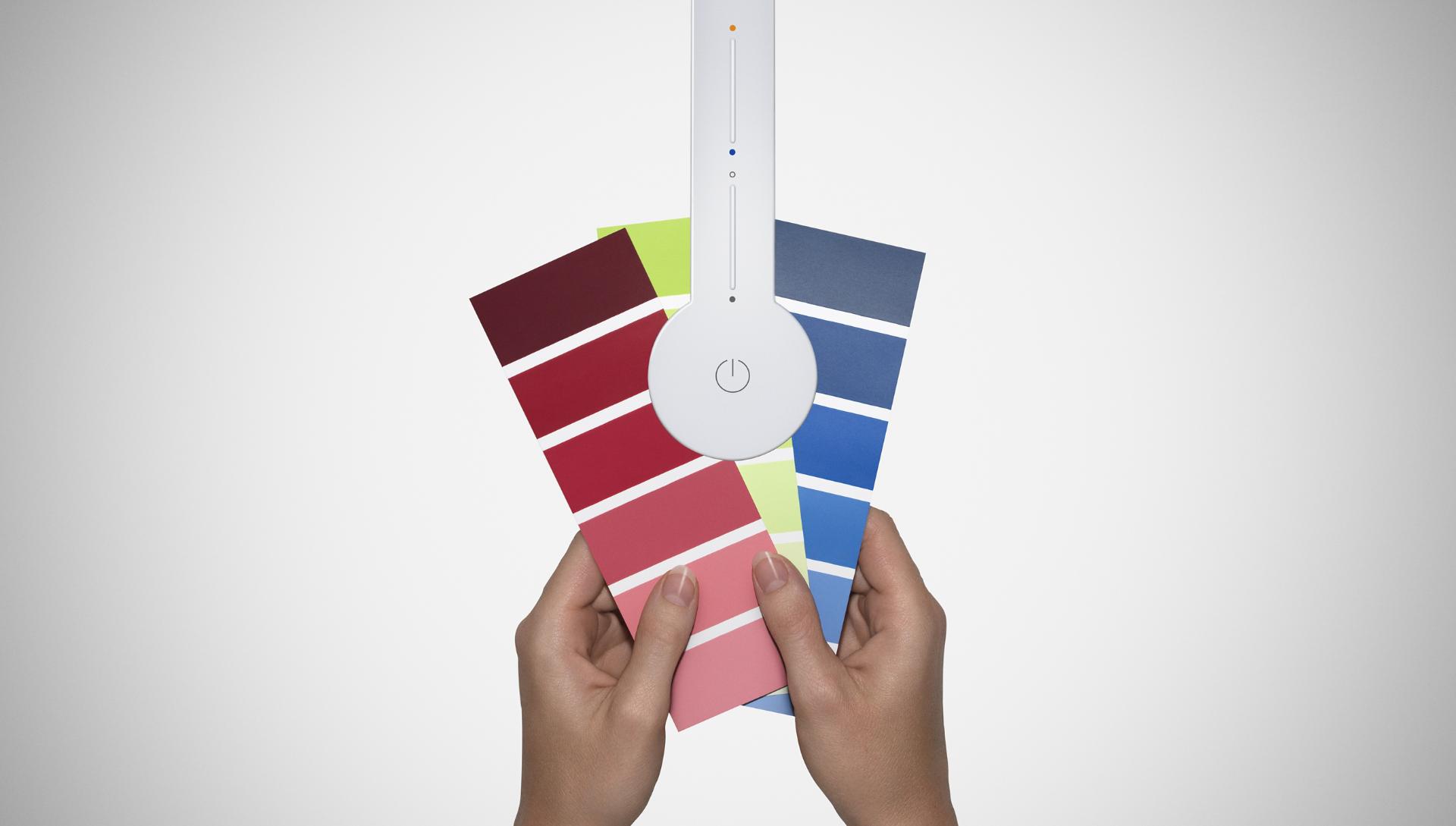 Dyson Lightcycle desk light with colour cards to show its lighting precision