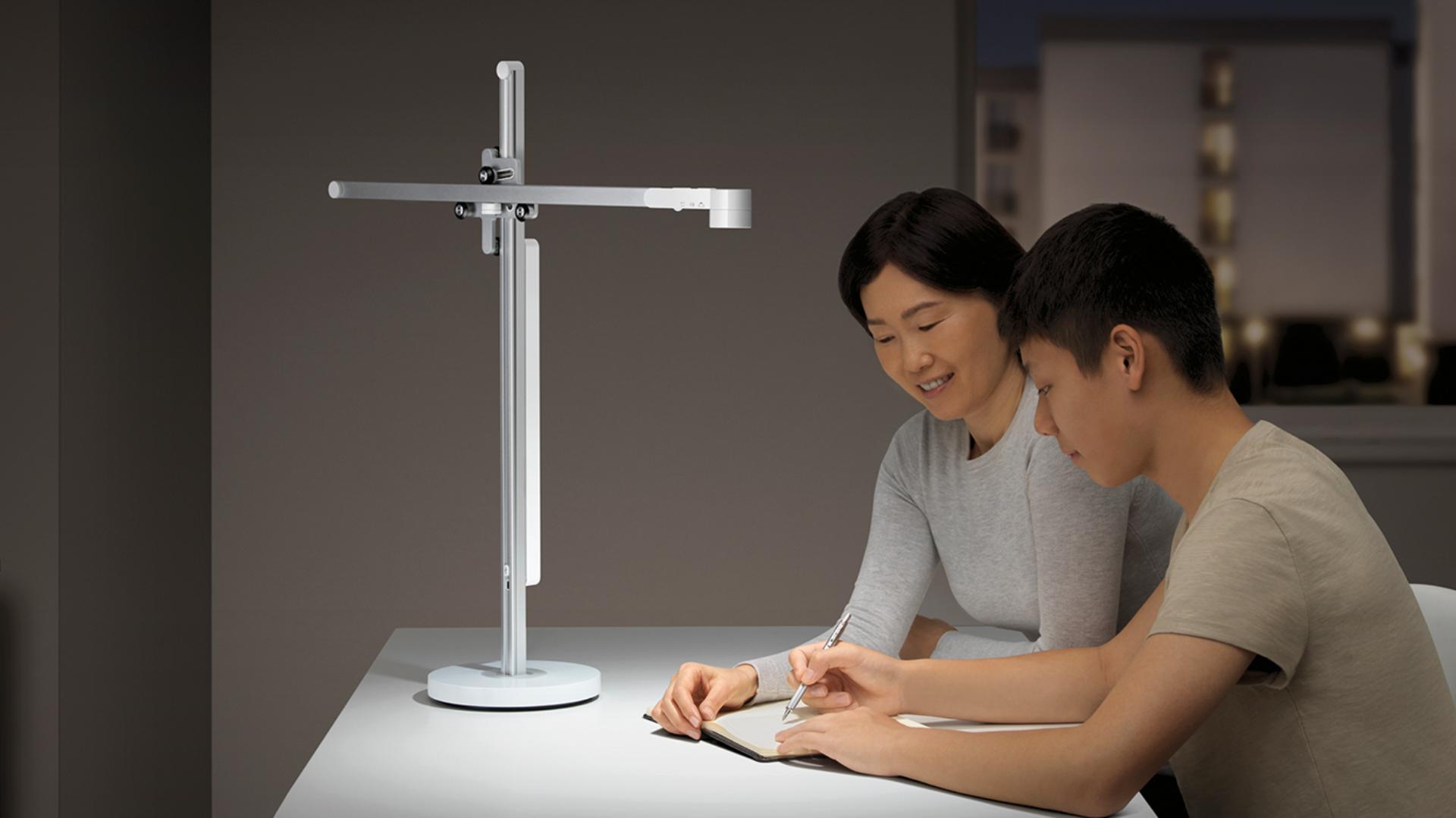 Mother and teenager studying under the Dyson Lightcycle task light