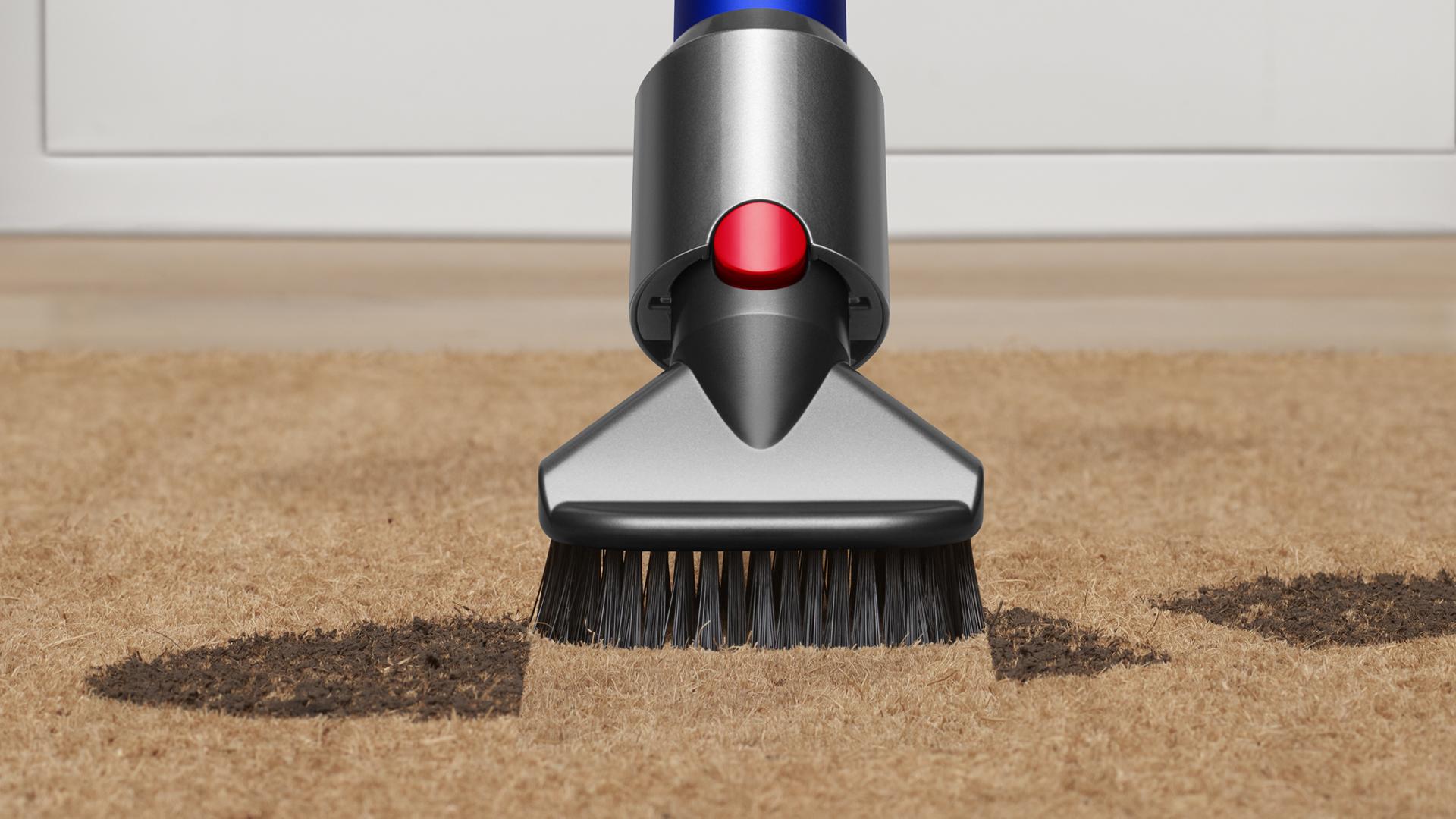 Stubborn dirt brush vacuuming ground in dirt